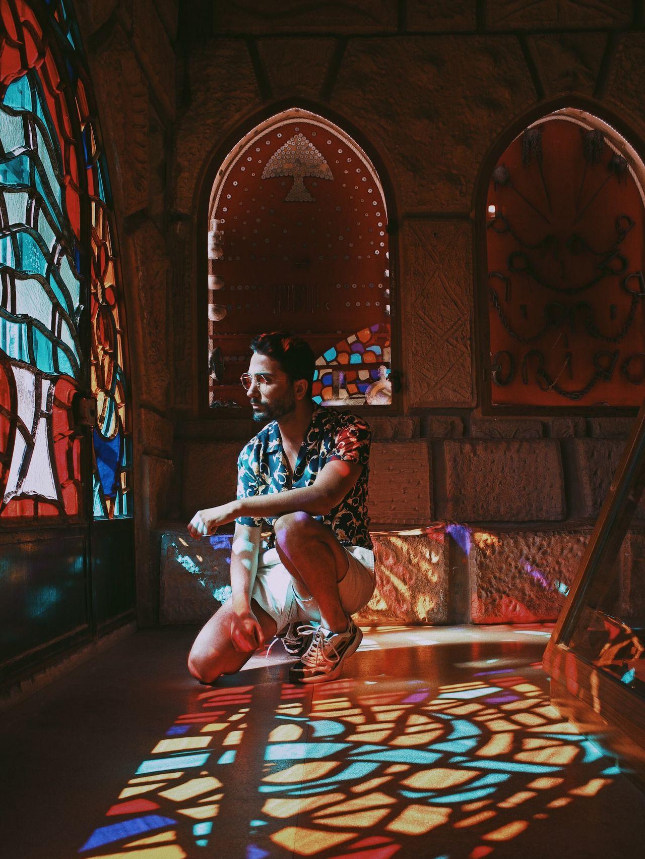 man beside stained glass windows